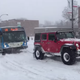 Illustration for article titled Watch a Whole Team of Off-Roaders Hitch Up to Save a Bus in a Snowstorm